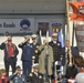 Rear Adm. Steven P. Metruck salutes with honored veterans