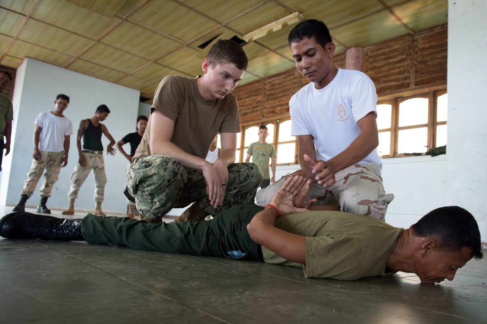 Coastal Riverine Group ONE Detachment Guam Sailors demonstrate mechanical advantage control hold takedown and handcuffing techniques to Royal Cambodia sailors and military police