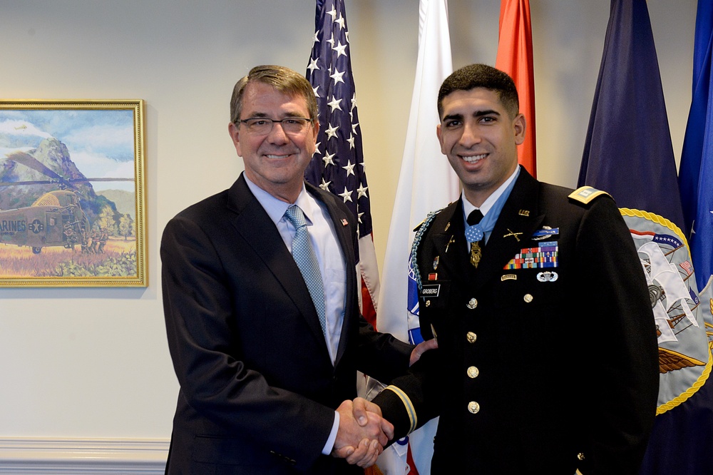 Secretary of defense takes a photo with retired Army Capt. Florent Groberg in his office before the Medal of Honor Hall of Heroes induction ceremony