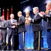 Secretary of defense congratulates retired Army Capt. Florent Groberg as he accepts a plaque