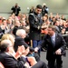 Secretary of defense shakes hands with retired Army Capt. Florent Groberg's family members at the Medal of Honor Hall of Heroes induction ceremony