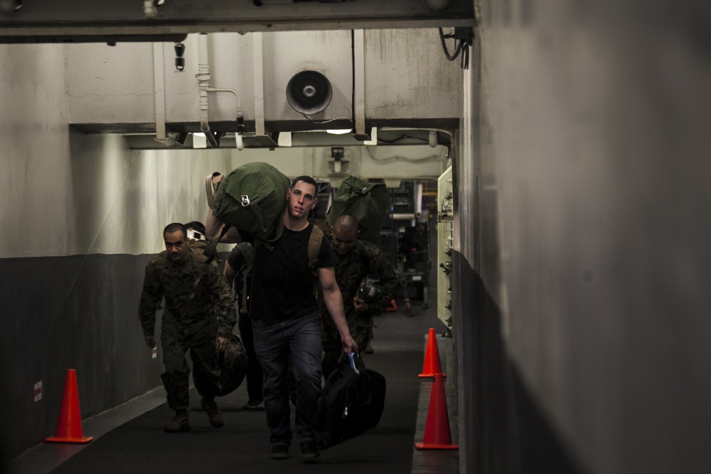 Load ‘em up: U.S. Marines prepare for flight at sea