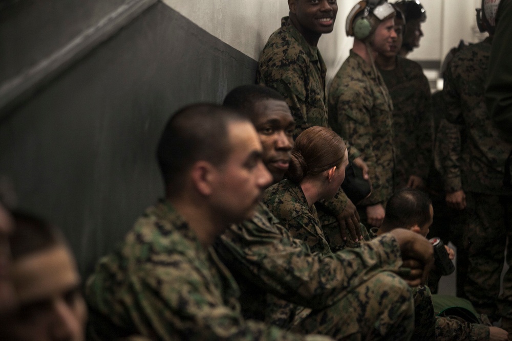 Load ‘em up: U.S. Marines prepare for flight at sea