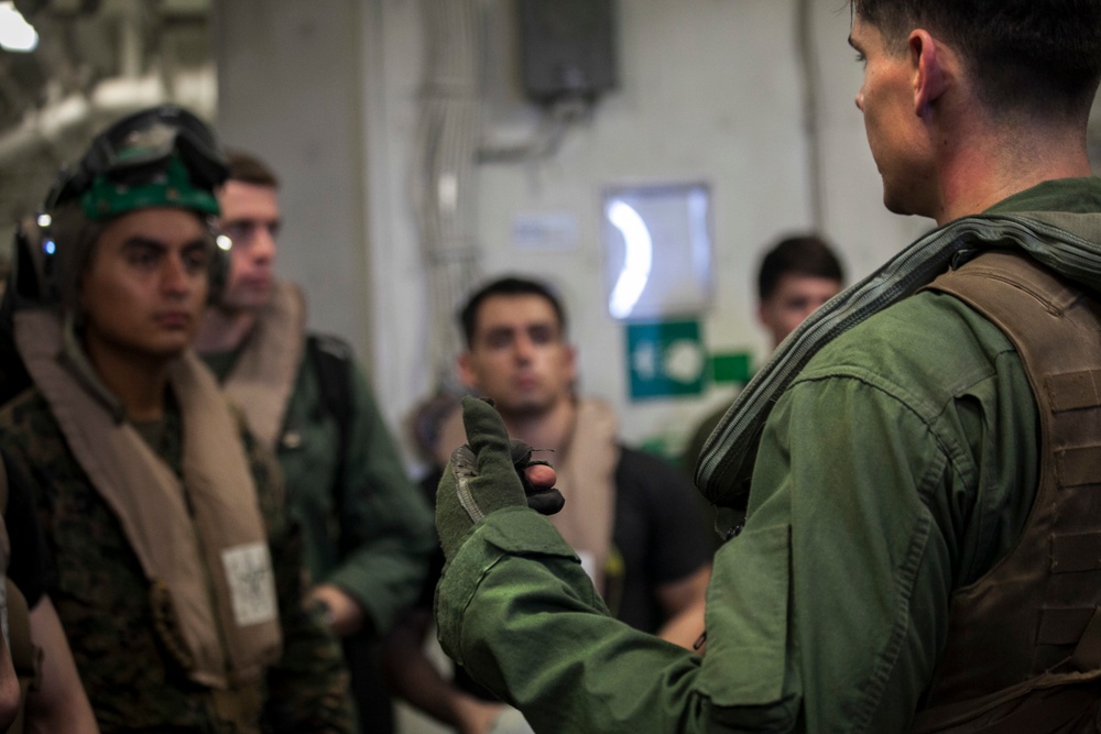 Load ‘em up: U.S. Marines prepare for flight at sea