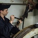 USS George Washington Sailor repairs a door wire