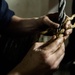 USS George Washington Sailor repairs a door wire