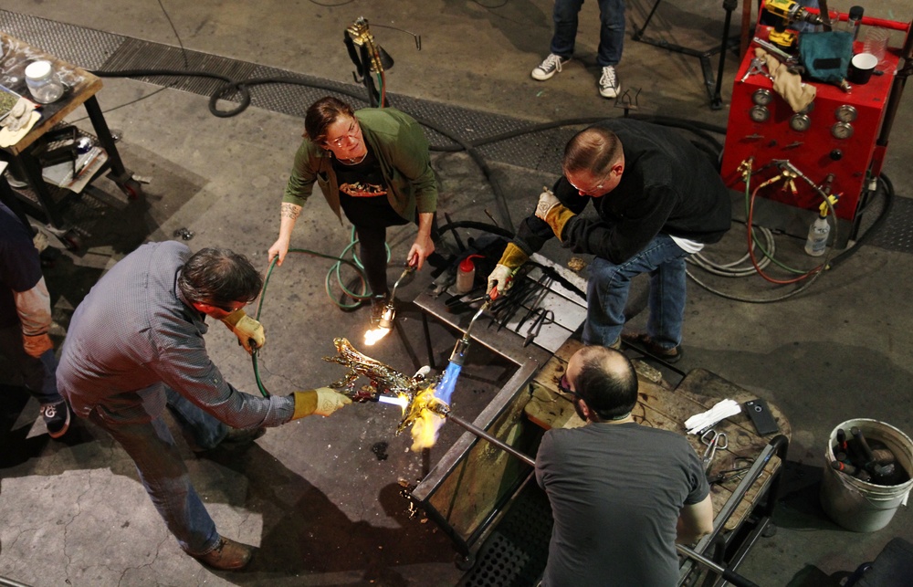 Hot shop heroes instructor and participants work on glass art