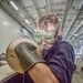 USS Dwight D. Eisenhower Sailor adds hydraulic fluid into flight deck scrubber