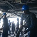 USS Dwight D. Eisenhower Sailor heaves in mooring line