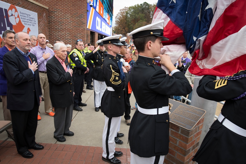 Col. Skardon watches the raising of the Colors