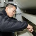 Nimitz Sailor performs arresting gear maintenance