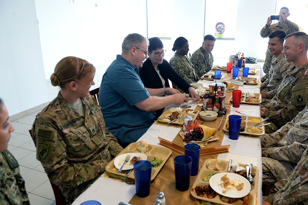 DSD signs a flag given to him from one of the members of the camp after Thanksgiving lunch at Camp Lemonnier, Djibouti