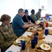 DSD signs a flag given to him from one of the members of the camp after Thanksgiving lunch at Camp Lemonnier, Djibouti