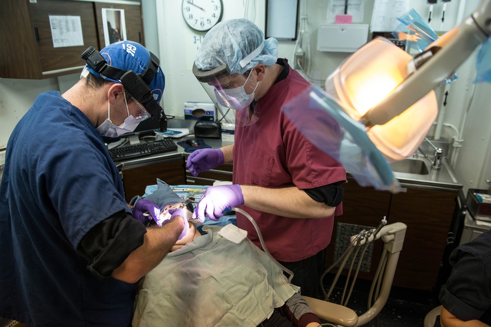 USS George Washington Sailors conduct dental operation