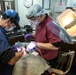 USS George Washington Sailors conduct dental operation