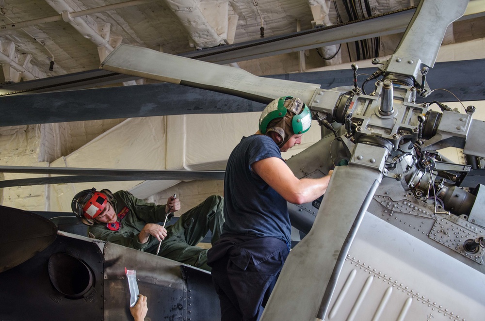 Helicopter Maritime Strike Squadron (HSM-35), perform scheduled phase maintenance for a MH-60R Seahawk helicopter aboard USS Fort Worth (LCS 3)