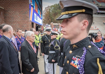 WWII veteran watches the raising of the colors