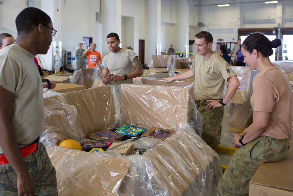 JASDF, RAAF and USAF work together building bundles in preparation for Operation Christmas Drop 2015