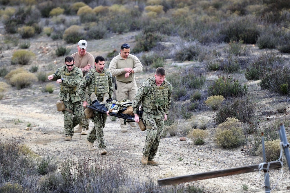 West Coast-based Sea, Air, Land (SEAL) Team evacuate a patient on a combat litter during a combat casualty simulation
