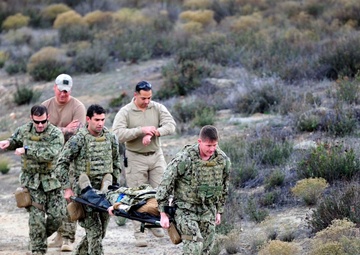 West Coast-based Sea, Air, Land (SEAL) Team evacuate a patient on a combat litter during a combat casualty simulation