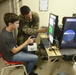 U.S. Marines and family members operate LAV simulator