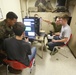 U.S. Marines and family members operate LAV simulator
