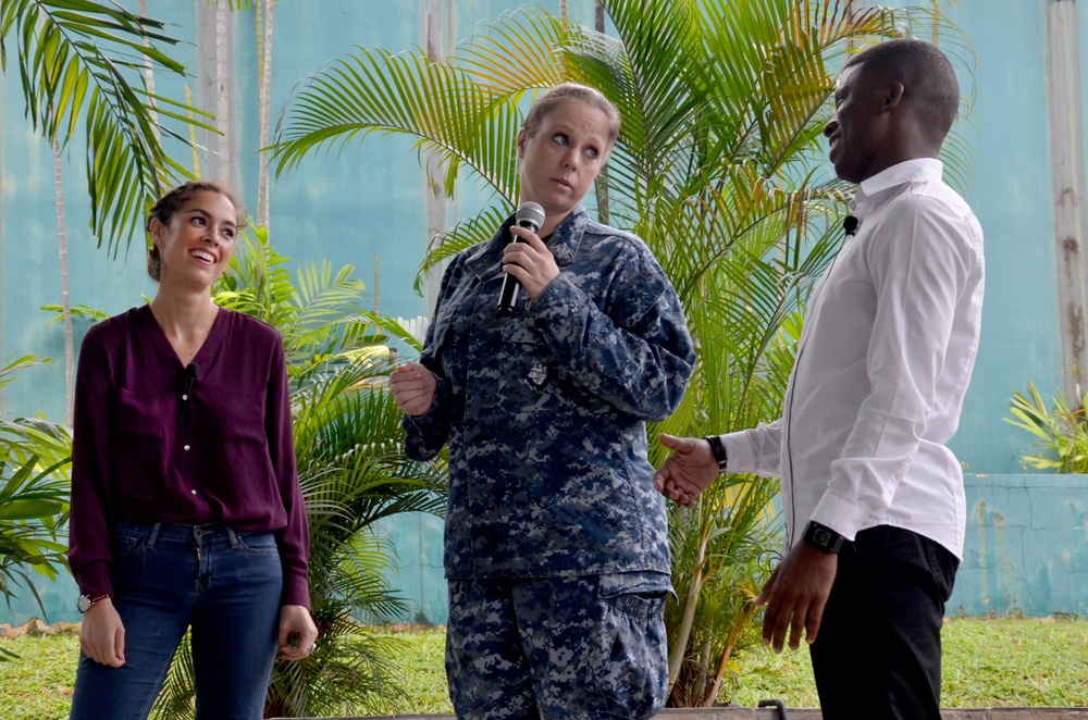 Information Systems Technician 1st Class Amanda Faust demonstrates proper bystander-intervention techniques with actors from Pure Praxis during Sexual Assault and Prevention training at the Terror Club amphitheater in Singapore Dec. 15