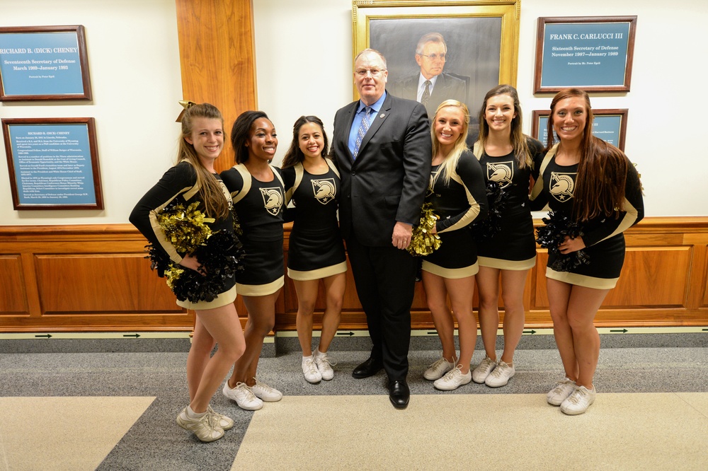 Deputy secretary of defense takes a photo with the Army pep rally band during their visit to the Pentagon