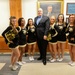 Deputy secretary of defense takes a photo with the Army pep rally band during their visit to the Pentagon