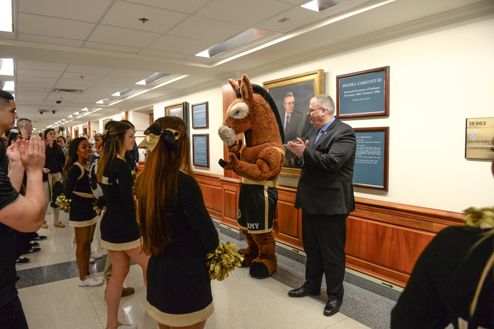 DSD claps as the Army a pep rally band and cheerleaders perform in the halls of the Pentagon