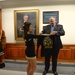 Deputy secretary of defense receives a shirt presented to him by the Army pep rally band and cheerleaders at the Pentagon