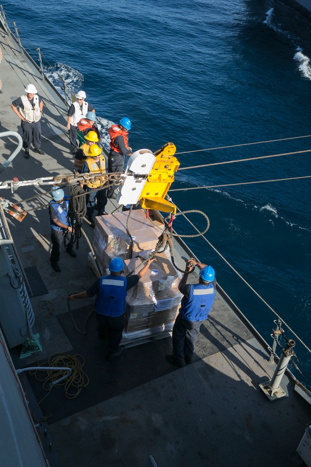 Marines and Sailors work together during replenishment-at-sea