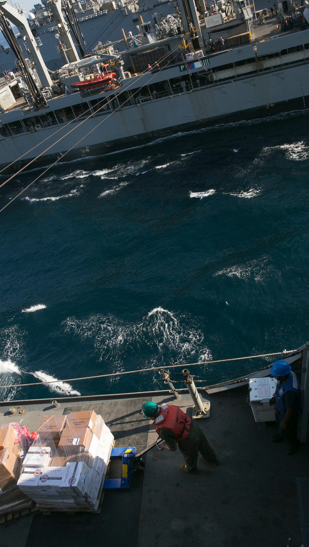 Marines and Sailors work together during replenishment-at-sea