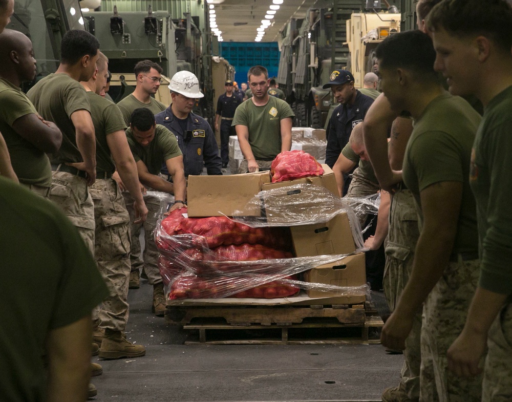 Marines and Sailors work together during replenishment-at-sea