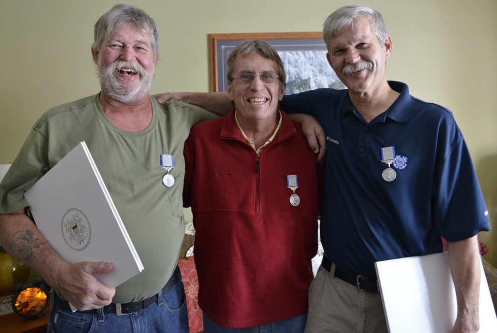 Three men receive Coast Guard Silver Lifesaving Medal