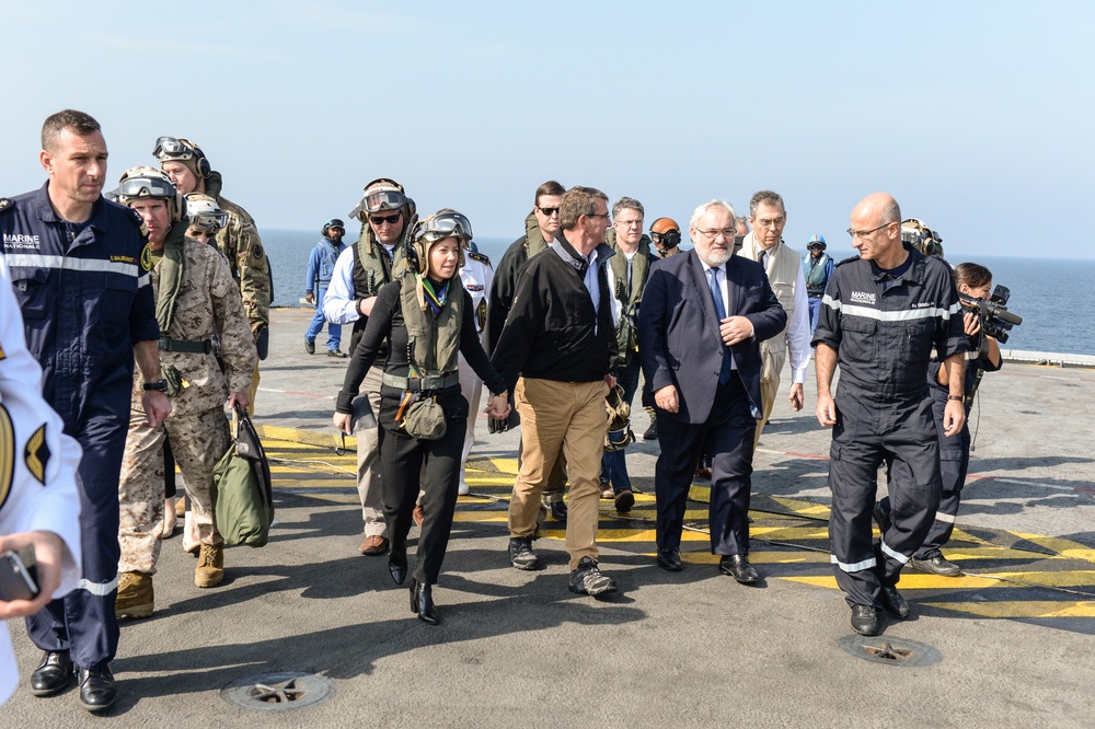 Secretary of defense and his wife, Stephanie, arrive on the deck of the flagship of the French Navy, the Charles De Gaulle