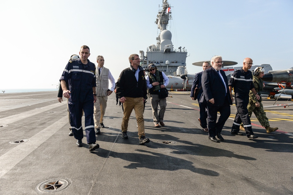 Secretary of defense departs the deck of the flagship of the French Navy, the Charles De Gaulle