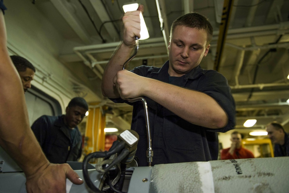 USS Kearsarge sailors assemble, inspect and move a GBU-54 bomb aboard USS Kearsarge
