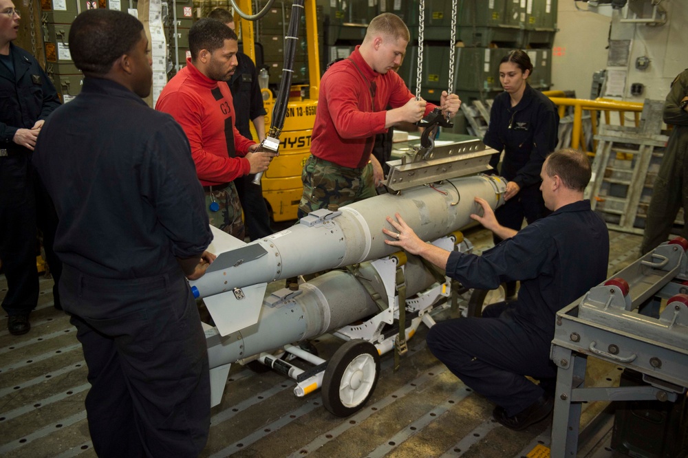 USS Kearsarge sailors assemble, inspect and move a GBU-54 bomb aboard USS Kearsarge