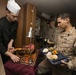 U.S. Marines and Sailors with the 26th MEU and USS Kearsarge share a Christmas meal