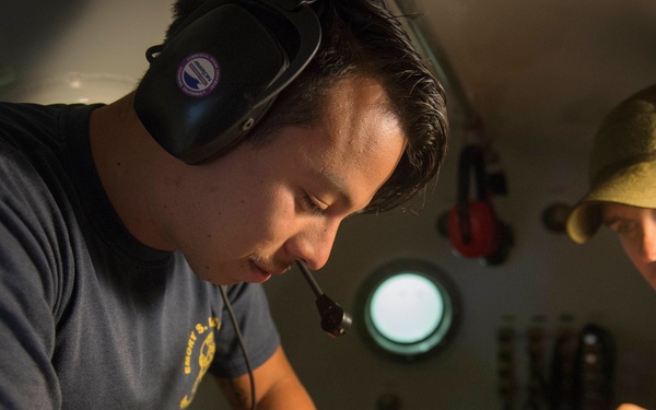 Navy divers inspect medical kit