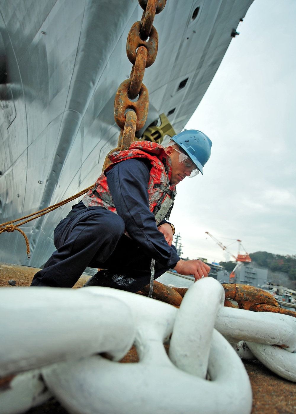 USS Blue Ridge sailor touches up anchor chain paint