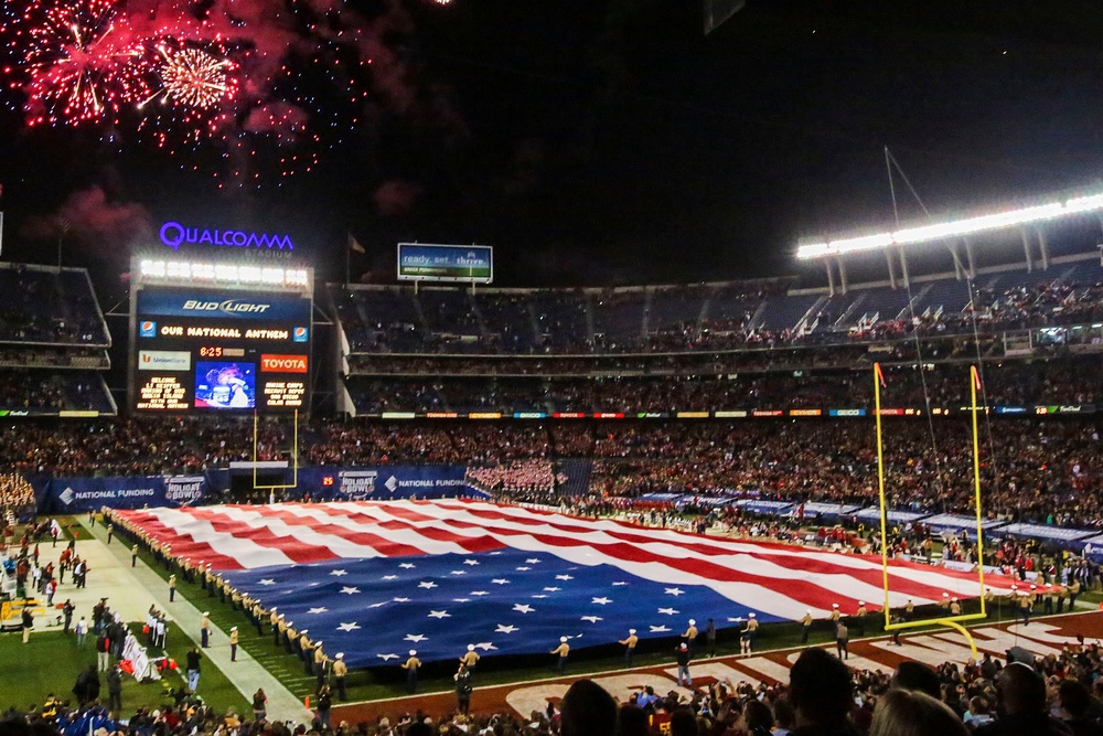 Marines stand together to unfurl Old Glory at 38th annual Holiday Bowl