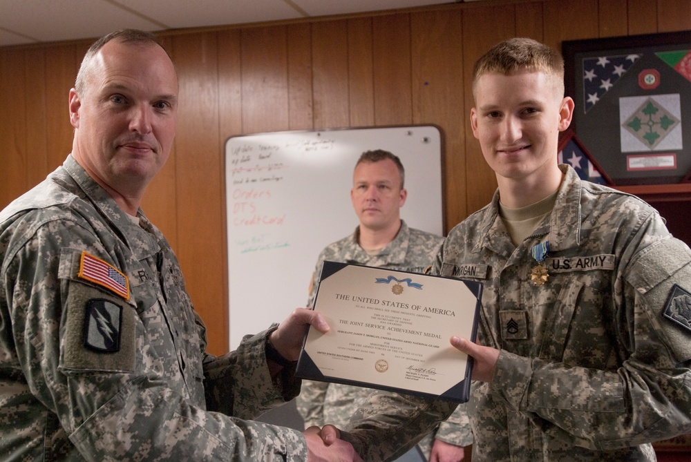 Brigadier general presents awards to Soldiers at the 102nd Public Affairs Detachment