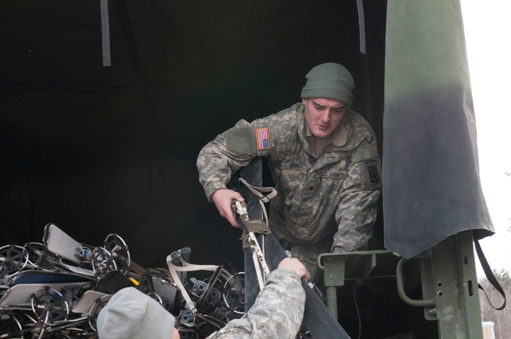 Soldier stacks LMTV with skis for mountain skills training