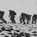Vermont National Guard Soldiers traverse a steep, rocky hill