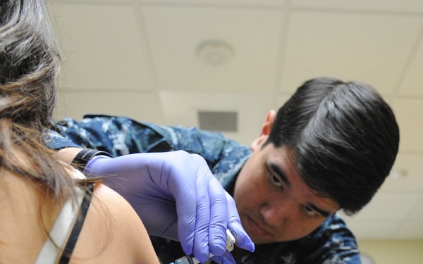 Sailor administers flu shot