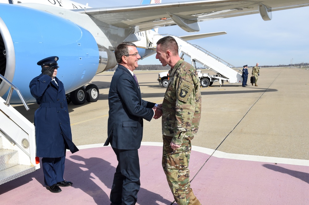 Secretary of defense is greeted by Maj. Gen. Volesky