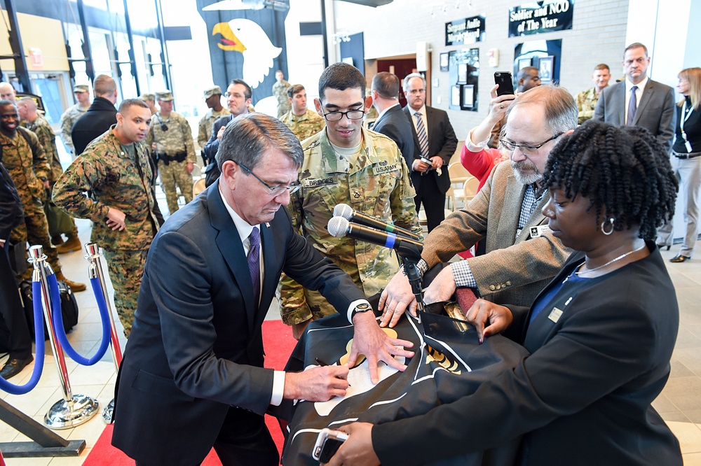 Secretary of defense signs a 101st Division flag for a deploying soldier