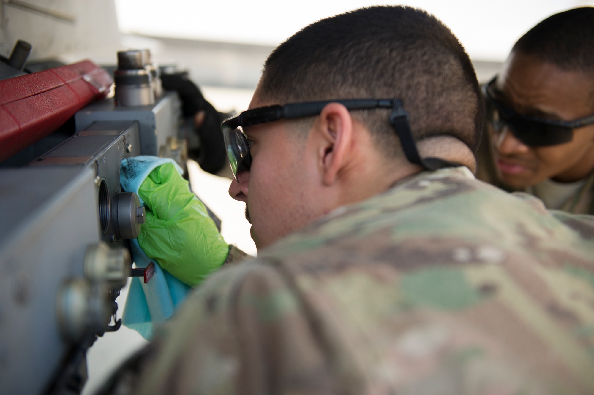 U.S. Air Force weapons load crew member servicing a BRU-57 on an F-16 at Bagram Air Field